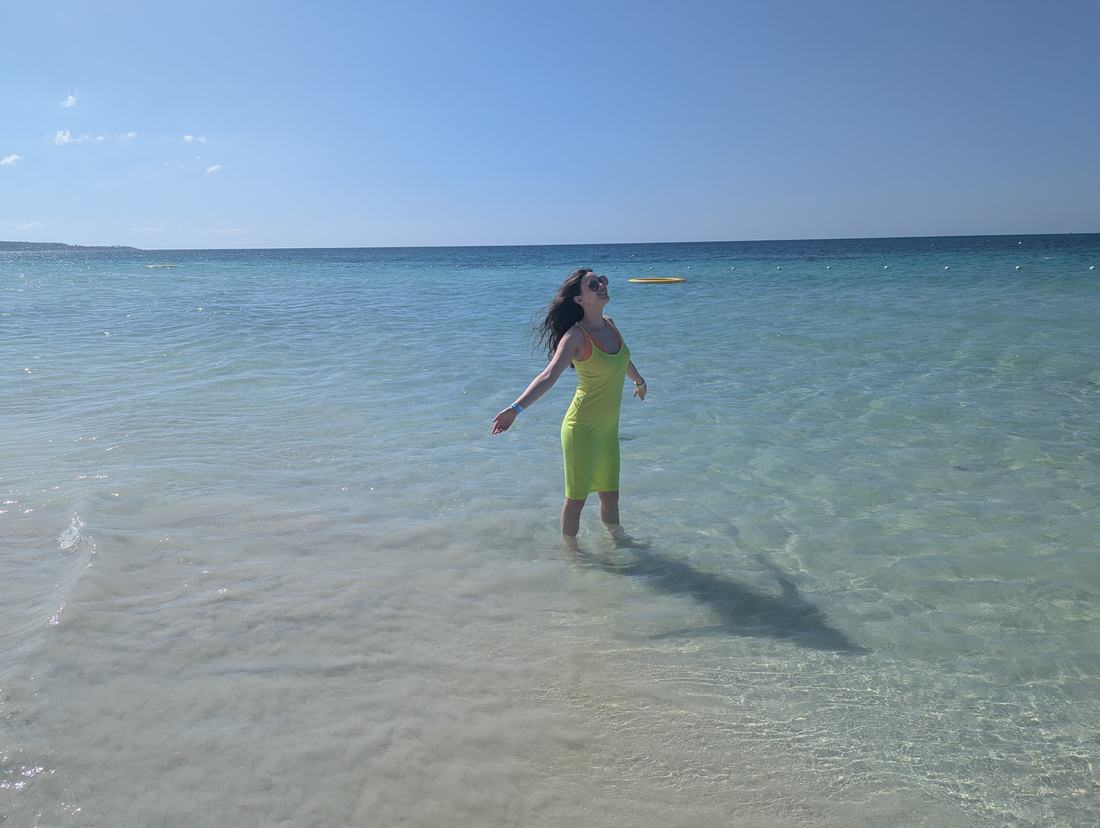 Wading in shallow turquoise water in Jamaica